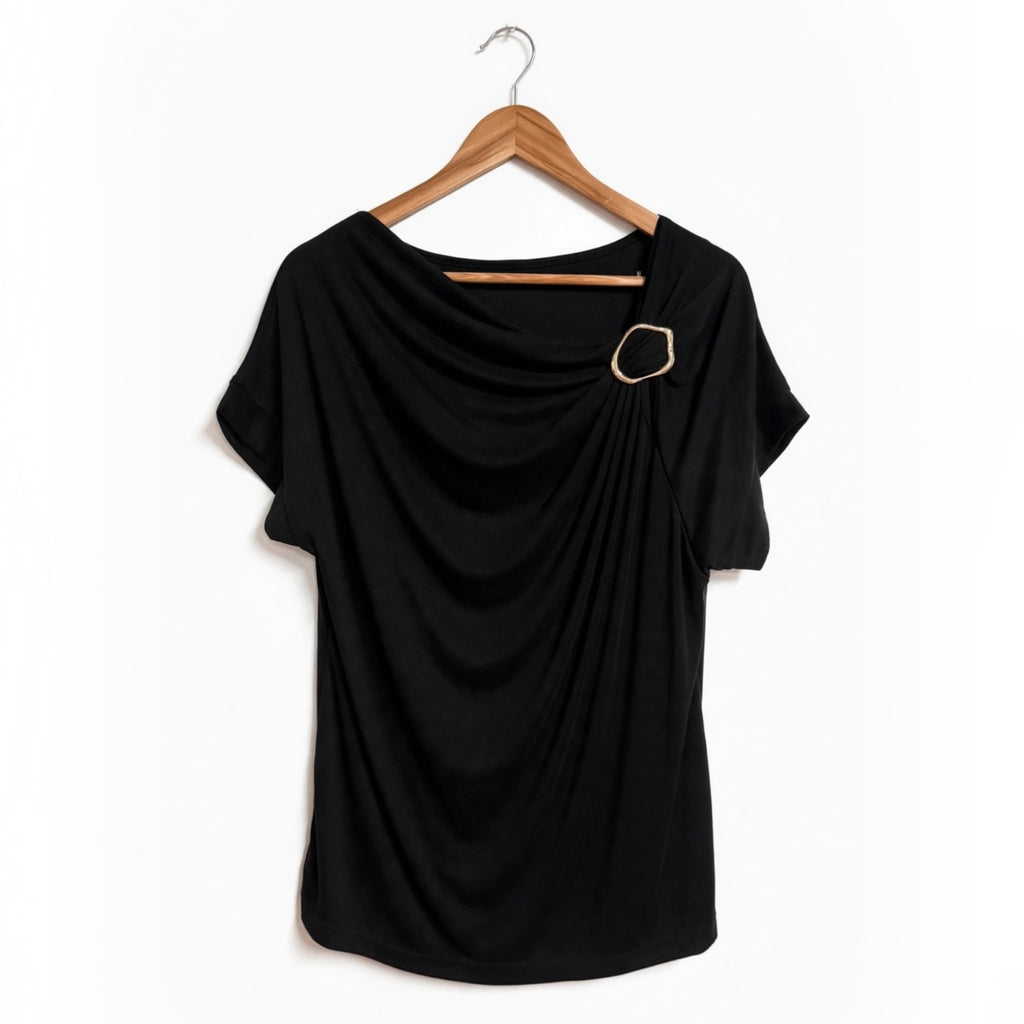 Blusa negra las cucadas de erisa con drapeado frontal, escote asimétrico y detalle de anilla metálica dorada.