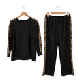 Conjunto deportivo las cucadas de erisa negro de dos piezas con detalles laterales de estampado animal print