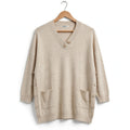 Jersey de punto las cucadas de erisa beige con cuello en V, botones decorativos, bolsillos frontales y laterales.