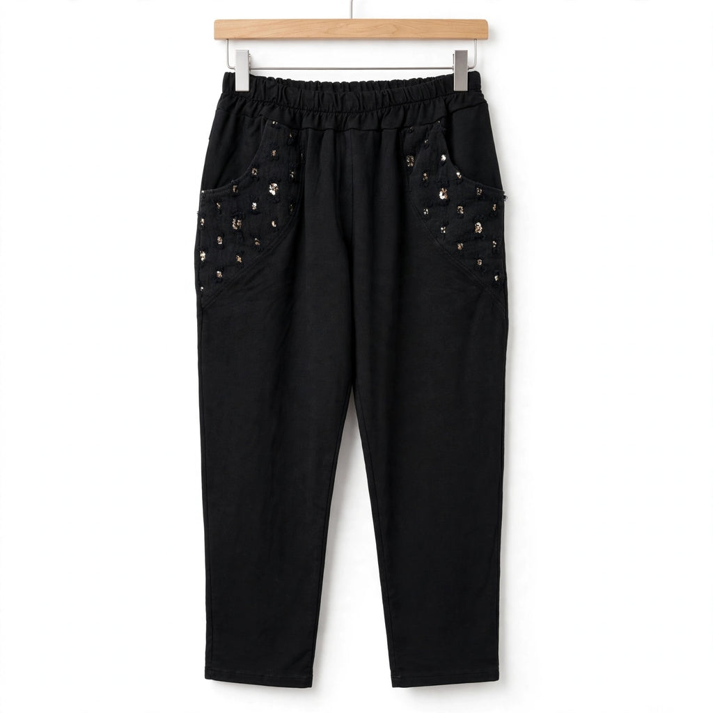 Pantalón negro casual de las cucadas de erisa con cintura elástica y bolsillos laterales decorados con lentejuelas.