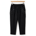 Pantalón negro casual de las cucadas de erisa con cintura elástica y bolsillos laterales decorados con lentejuelas.